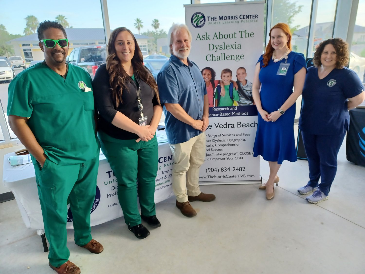 Tarone Claybrook, Alyssa Sommer, Dr. Tim Conway, Dr. Robin Edge and Anna Sanders, from left, greet visitors at the link’s July 15 Business Expo. The Morris Center offers prevention and remediation services for dyslexia and other learning disorders.